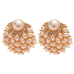 Vintage gold stud earrings with large pearl centers and crystal halo on white background