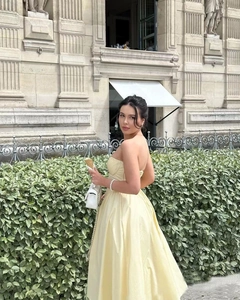 Elegant strapless pale yellow satin maxi dress with a flattering corset waist and bow detail