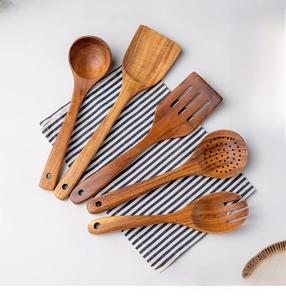 Detailed view of 5-piece teak wood cooking utensil set with natural grain and hanging holes