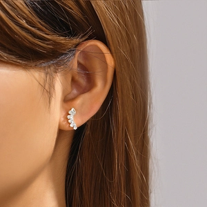 Close-up of s925 sterling silver moon-shaped earring with rectangular gemstones on ear