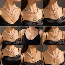 Detail showing nine styles of multilayered gold necklaces with pearls and coin pendants