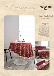 Close-up of red American style jacquard tablecloth with geometric patterns and white fringe