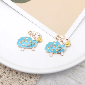 Detail of blue and white cartoon sheep alloy charms with gold-tone edges for DIY jewelry