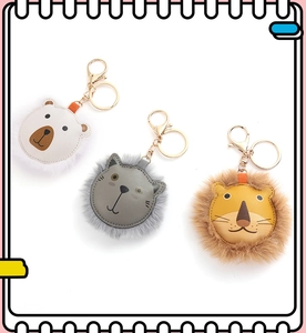 Detailed shot of cute plush bear and lion keychains with golden lobster clasps and rings