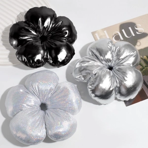 Detailed close-up of large 3D fabric flower hair scrunchies in metallic and sequin finishes
