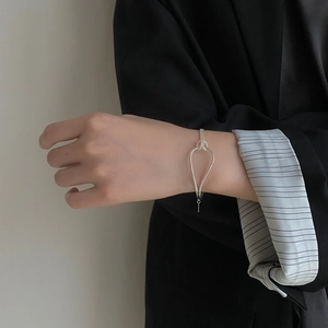 S925 Sterling Silver minimalist knot bracelet with teardrop design on model's wrist