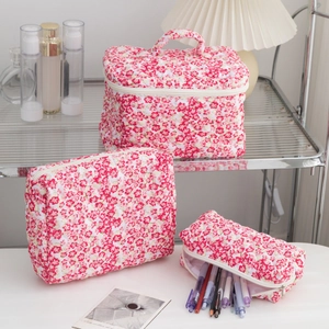 Three-piece pink floral quilted cotton makeup bag set for travel and storage
