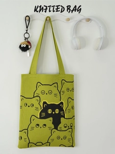 Green knitted tote bag with cute cartoon cat pattern and long shoulder straps