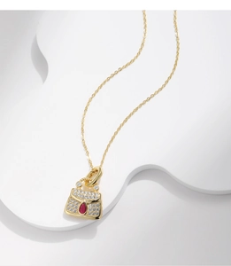 Detail of S925 sterling silver handbag pendant necklace with gold plating and crystals