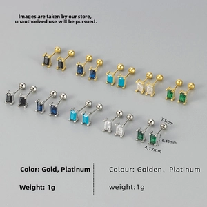 Macro shot of rectangular zircon screw back earrings in gold and platinum finishes