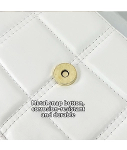 Detailed macro view of quilted leather texture and a durable gold magnetic hardware buckle