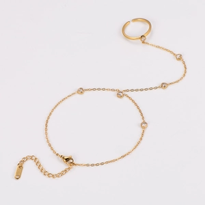 Detail of 18K gold finger bracelet featuring heart-shaped zircons and K18 engraving