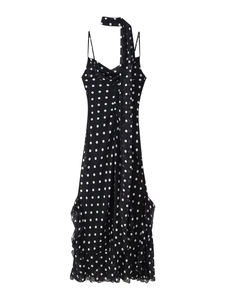 Detailed close-up of a black polka dot ruffle dress featuring an elegant matching neck scarf