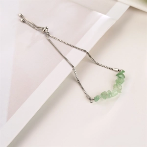 Detail of adjustable stainless steel chain bracelet with light green crushed natural stones