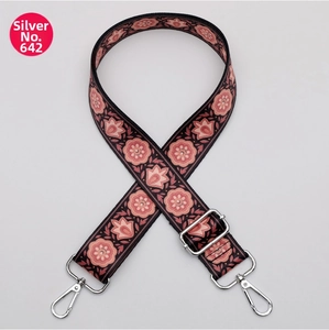 Close-up of pink floral ethnic strap with adjustable silver hardware lobster clasps