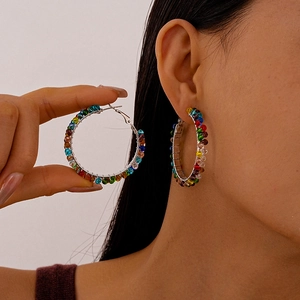 Elegant silver hoop earrings with colorful glass beads shown on a model