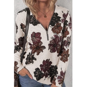 Detail van de V-hals rits op top met lange mouwen en retro bloemenprint op gebroken witte stof