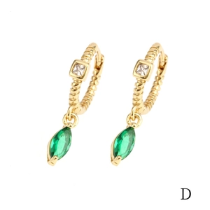 Detail of 18K gold earrings with spiral texture, square diamond and green marquise stone