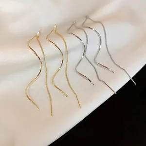 Minimalist twisted geometric wave threader earrings in gold and silver set on silk