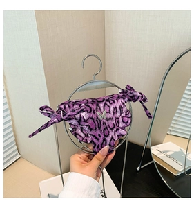 Detail of purple leopard print bikini bottom with silver butterfly charm and side ties