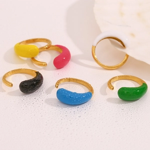 Detail of six colorful teardrop enamel rings in gold finish with water drop texture