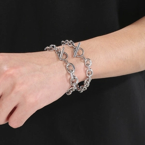 Close-up of a chunky silver stainless steel O-chain bracelet with a stylish OT toggle clasp