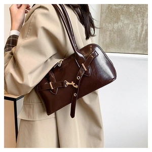 Detail of dark brown vintage bowling bag with belt buckle and Fashion embossing