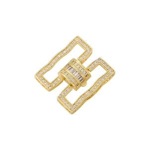 Detailed macro of gold plated geometric jewelry clasp with micro-pave cubic zirconia stones