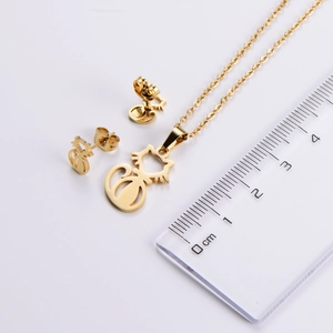 Cat jewelry set measurements featuring gold-tone cat pendant and earrings beside a ruler