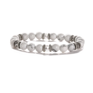 Detailed macro shot of white turquoise beads with vintage silver spacers on elastic bracelet