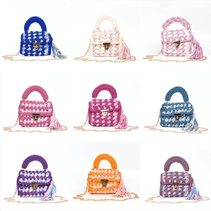 Collage of handmade colorful knit mini crossbody bags with gold chains and tassels