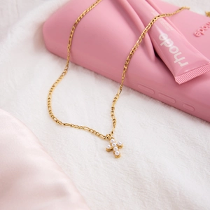 Elegant 18k gold stainless steel cross necklace with white pearl on soft fabric