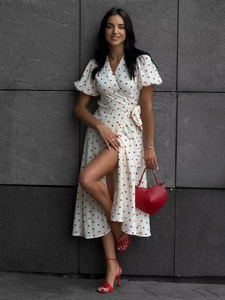 Detailed view of wrap dress with red heart print, V-neckline and side tie-waist detail