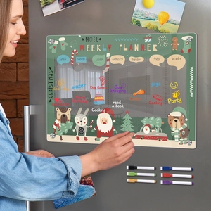 Detailed view of a woman using a Christmas magnetic acrylic weekly planner on a fridge
