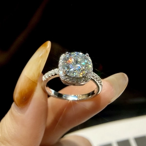 Close-up of S925 silver moissanite ring with brilliant sparkle held by hand