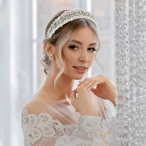 Detail of elegant headband with pearls and rhinestones worn by a model in bright light