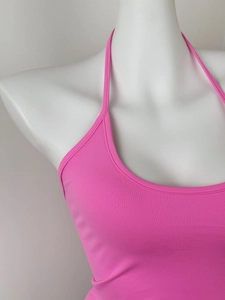 Close-up of rose pink halter neck top with ribbed knit texture on a white mannequin