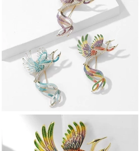 Close-up of vintage phoenix enamel brooch with colorful gemstone inlay and metal pin