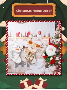 Close-up of three knitted Christmas stockings with Santa, snowman and reindeer designs