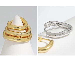 Detail shot of S925 sterling silver hallmark on minimalist gold and silver hoop earrings