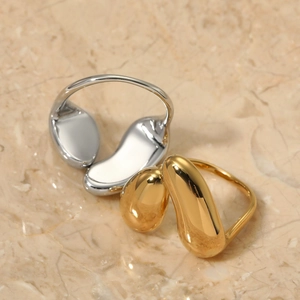 Irregular organic flow minimalist ring in gold and silver finish on marble
