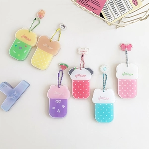 Flat lay of colorful acrylic cartoon magnetic photo frames with cute charms and bead chains