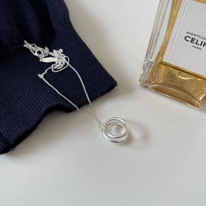 Detailed view of 925 silver irregular oval pendant necklace on blue knit fabric