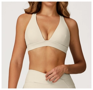 Detailed view of cream high-stretch yoga set featuring racerback bra and high-waist leggings