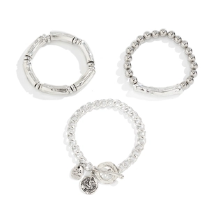 Detailed view of 3-piece silver metal beaded bracelets with heart charms and toggle clasp