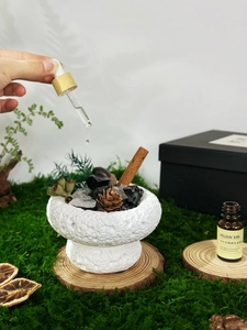 Essential oil diffuser set with crystals, cinnamon and pine cones in a black gift box