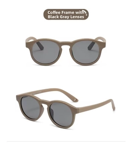 Detail view of coffee-colored round baby sunglasses with gray lenses and CE mark