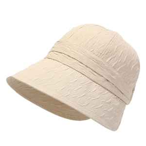 Foldable beige sun hat with textured fabric and wide brim for summer protection