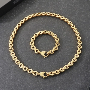 Macro detail of gold-plated twisted spiral link necklace and bracelet set with lobster clasp