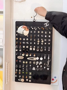 Detail of double-sided felt jewelry organizer with rotating hook for earrings and glasses